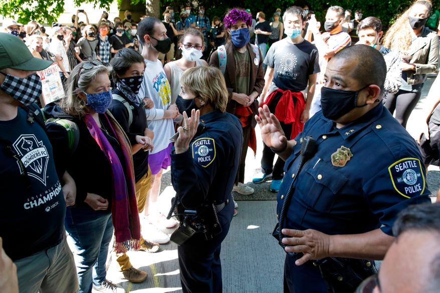 Seattle Police Assistant Chief Deanna Nollette and Assistant Chief Adrian Diaz are blocked by protesters from entering the Capitol Hill Autonomous Zone .