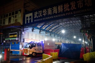 A Wuhan Hygiene Emergency Response Team drive their vehicle as they leave the closed Huanan Seafood Wholesale Market in Wuhan, China.