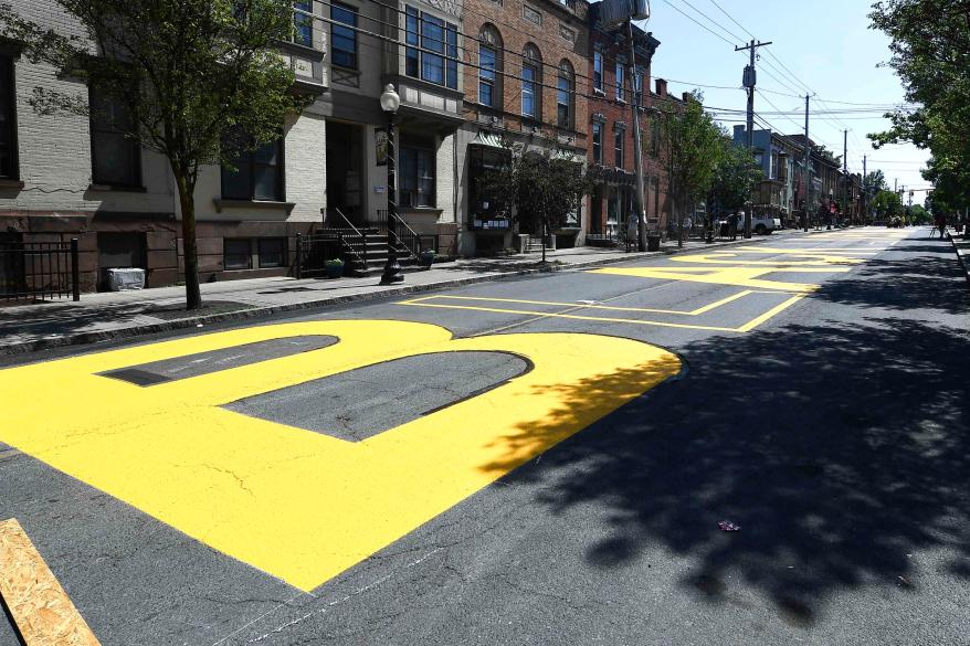 Paint crews from Straight Line Industries from Cohoes, N.Y., work with the city of Albany to paint Black Lives Matter on Lark Street today.