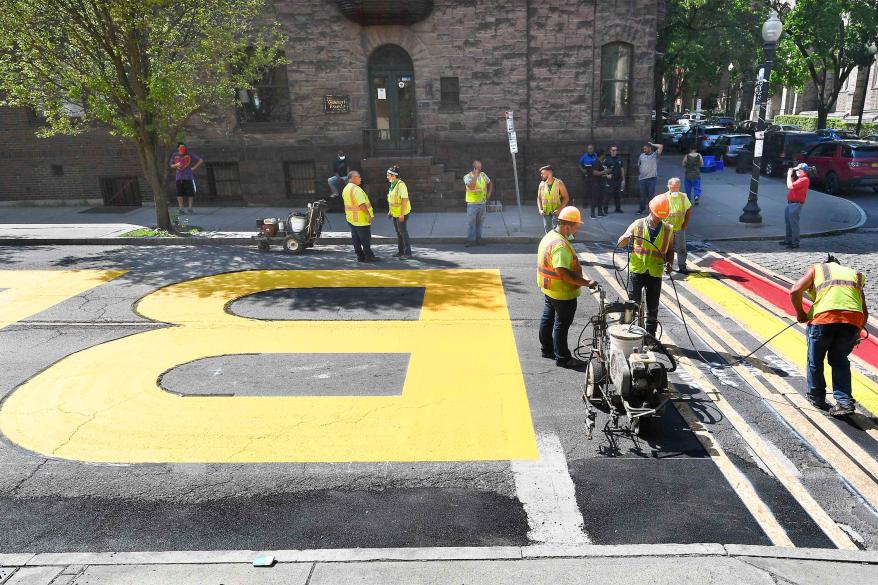 Paint crews from Straight Line Industries from Cohoes, N.Y., work with the city of Albany to paint Black Lives Matter on Lark Street today.