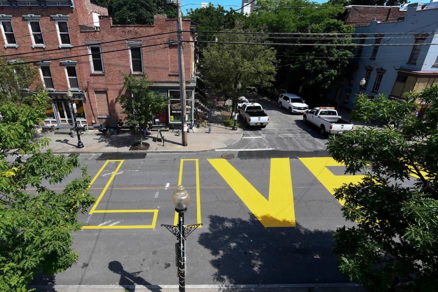 Paint crews from Straight Line Industries from Cohoes, N.Y., work with the city of Albany to paint Black Lives Matter on Lark Street today.