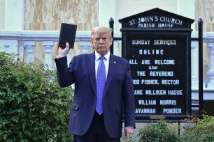 Donald Trump holds up a Bible outside of St John's Episcopal church across Lafayette Park in Washington, DC.