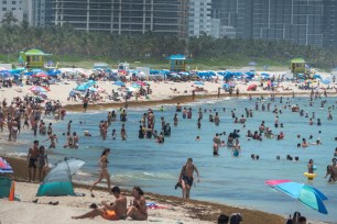 People spend a warm day at the beach in Miami Beach, Florida.