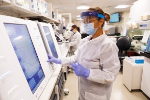 A medical technologist processes test samples for coronavirus in Tampa, Florida.