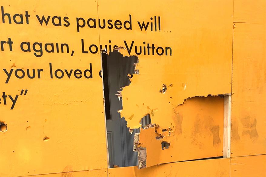 Vandalized Louis-Vuitton sign