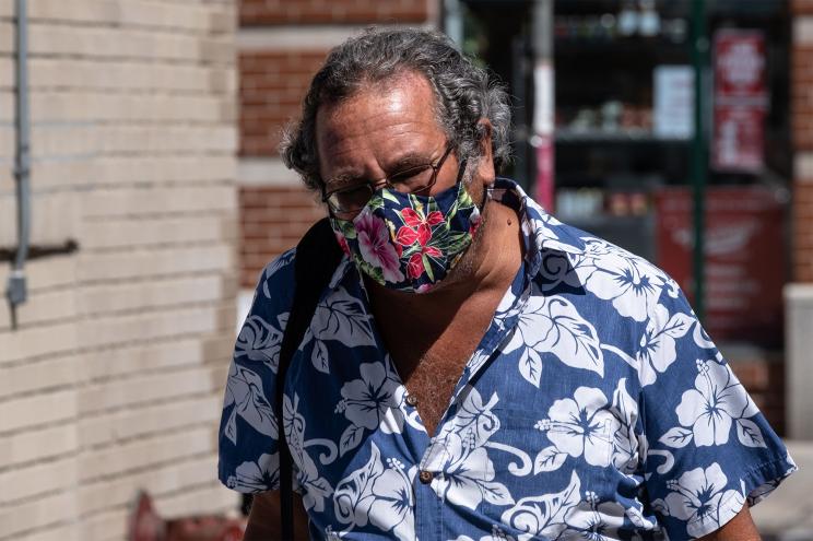 A man walking with a face mask in Manhattan.