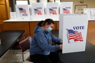 A voter fills out an absentee ballot in Garden City, Michigan.