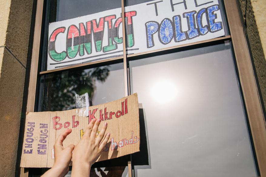 People paste signs on the windows of the 2nd Precinct Police Station during a demonstration on June 25, 2020 in Minneapolis, Minnesota.