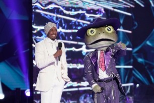 The Masked Singer: L-R: Host Nick Cannon and The Frog in the all-new Couldnt Mask For Anything More: The Grand Finale! season finale episode of THE MASKED SINGER airing Wednesday, May 20 (8:00-9:01 PM ET/PT) on FOX. (Photo by FOX via Getty Images)