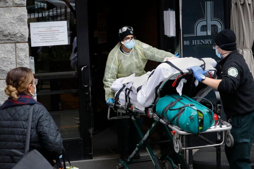 A patient is wheeled into Cobble Hill Health Center by emergency medical workers in the Brooklyn.