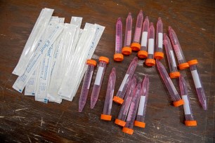 Test swabs and specimen tubes at a COVID-19 testing site.