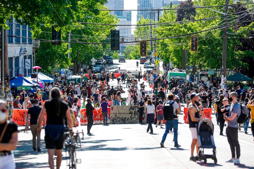 People walk around the newly created Capitol Hill Autonomous Zone in Seattle.