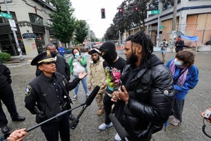 Rapper and activist Raz Simone, right, talks with Seattle Police Chief Carmen Best in the cop-free protest zone dubbed the CHAZ.