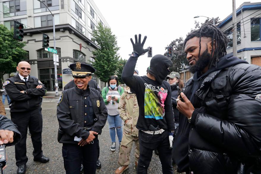 Rapper and activist Raz Simone, right, talks with Seattle Police Chief Carmen Best.