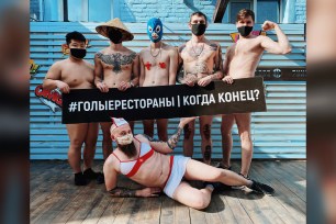 Employees of the Funky Food 11 restaurant wearing face masks pose for a photo without clothes to draw attention to a crisis in the restaurant industry caused by the lockdown measures imposed to prevent the spread of the coronavirus in Krasnodar, Russia. The banner reads, ”Naked restaurants. When is the end?"
