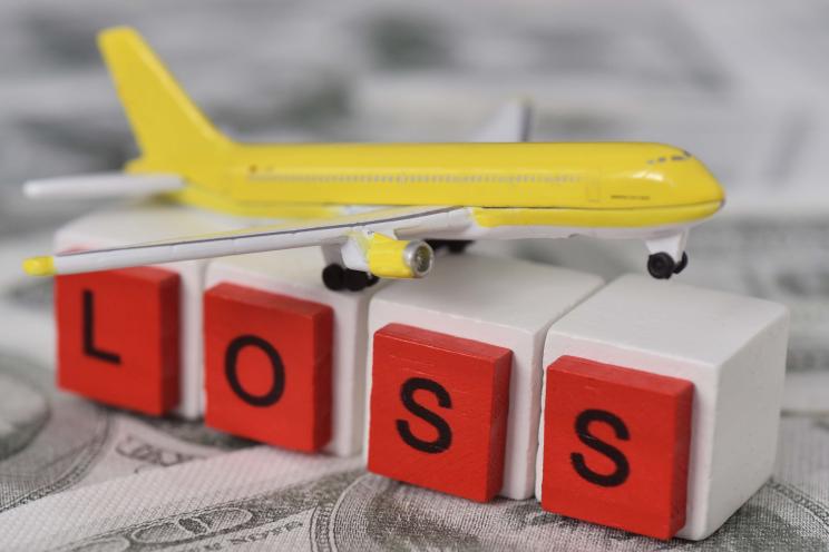 Model of an airplane with the word loss underneath