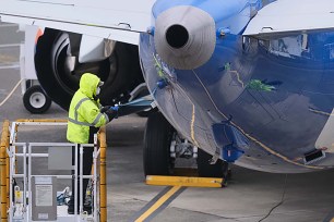 An employee works on a 737 Max at a Boeing manufacturing facility