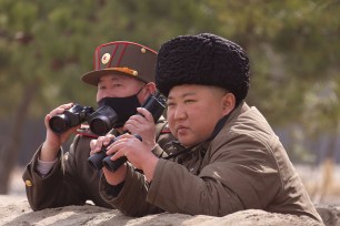 Kim Jong-Un supervising a "strike drill" together with a high ranking officer.