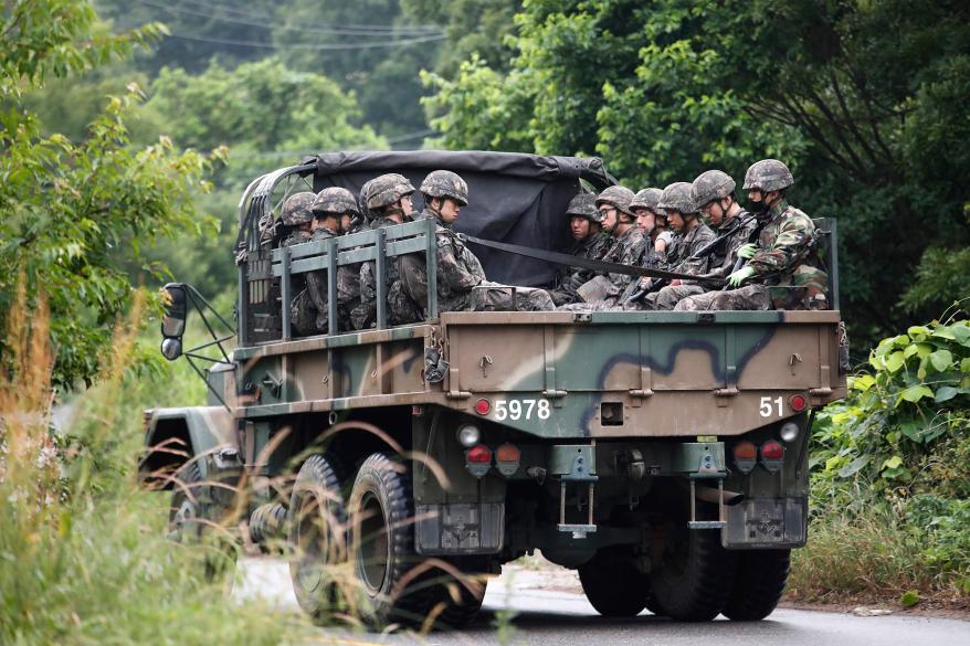 South Korean army soldiers ride on the back of a truck in Paju, South Korea, near the border with North Korea.