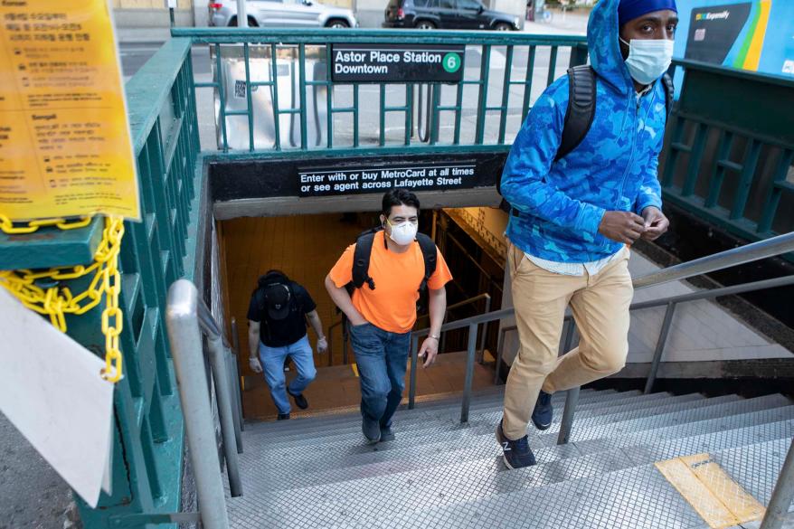 People come out of the Subway station at Astor Place in Manhattan.