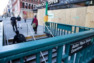 People come out of the Subway station at Astor Place in Manhattan.