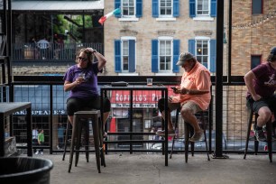 A couple sit at a bar in Austin, Texas.