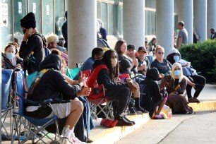 Hundreds of unemployed Kentucky residents wait in long lines outside the Kentucky Career Center in June 2020.