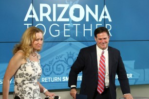 Arizona Gov. Doug Ducey, right, and Dr. Cara Christ, director of Arizona Department of Health Services