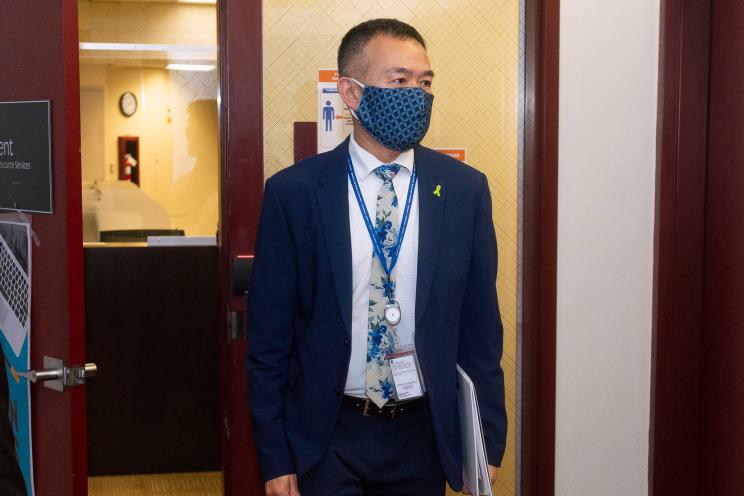 Orange County Health Care Agency Director and Interim Public Health Officer Dr. Clayton Chau, right, enters a COVID-19 news conference with Orange County Executive Officer Frank Kim in Santa Ana, Calif.