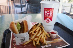 A Wendy's burger with a drink and fries.