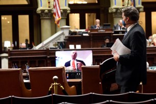 New York State Assemblyman William Colton (D-Brooklyn) is seen on a video screen voting remotely on new legislation for police reform during an assembly session at the state capitol in Albany, New York.