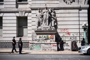 The graffiti-marred Surrogates' court across the street from "Occupy City Hall" in lower Manhattan.