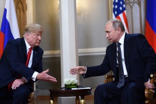 President Trump and Russian President Vladimir Putin shake hands before a 2018 meeting in Helsinki.