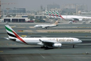 An Emirates airline passenger jet taxis on the tarmac at Dubai International airport in Dubai, United Arab Emirates.