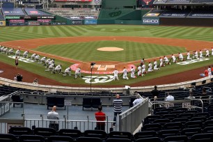 Yankees and Nationals players kneel before the national anthem in Thursday night's opener.