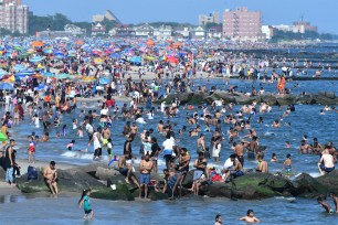 People at Coney Island beach on Independence Day.