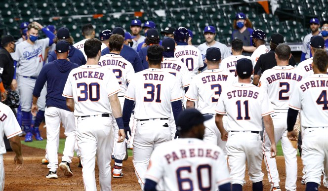 Benches empty out after the Dodgers' Joe Kelly threw several high inside pitches to the Astros' Alex Bregman, Yuli Gurriel and Carlos Correa in the sixth inning.