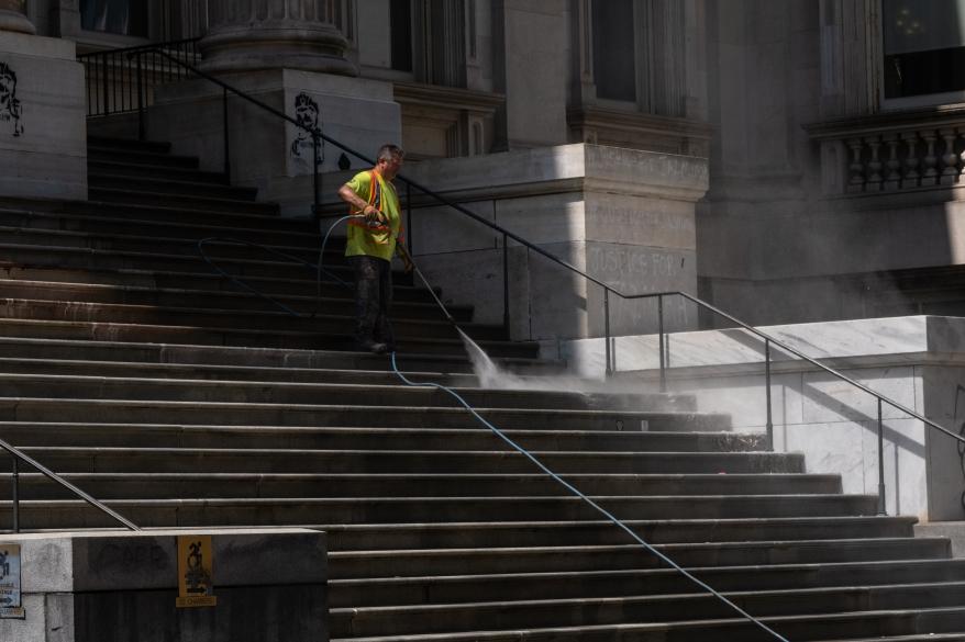 MTA workers cleaning outside the Brooklyn Bridge City Hall station.