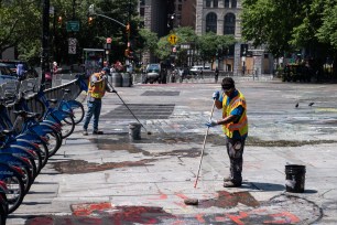 MTA workers cleaning outside the Brooklyn Bridge City Hall station.