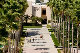 Cal State Fullerton students walk on campus near the Titan Student Union.