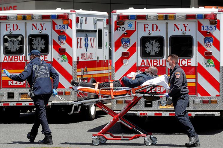 New York City Fire Department (FDNY) EMT's arrive with a patient at St. John's Episcopal Hospital, during the outbreak of the coronavirus disease