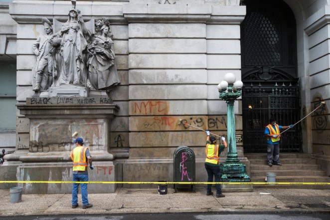 Workers washing the graffiti off of 31 Chambers Street steps in Manhattan