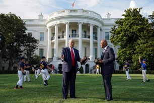 Donald Trump talks with former hall of fame pitcher Mariano Rivera while hosting youth baseball players at the White House