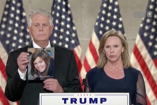 Carl Mueller holds up a photo of his daughter Kayla Mueller, who was killed by ISIS, while speaking with his wife Marsha in Washington, DC.