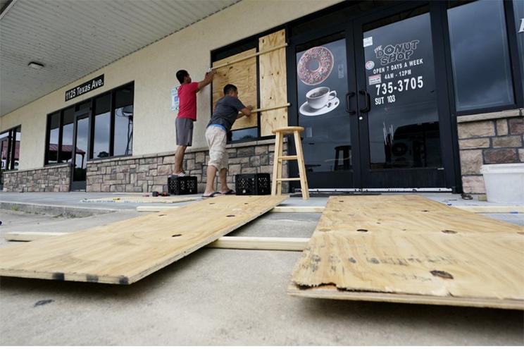 Daoith Porm and Bunsant Khov, board their business with Hurricane Laura just hours away.