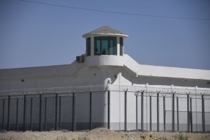 watchtower on a high-security facility near what is believed to be a re-education camp