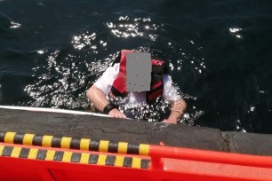 Man (blurred face) floating in water with life jacket