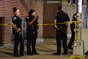 Police at the scene where a woman was shot on W170th Street near Aqueduct Avenue on August 27.