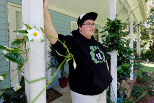 Gavin Grimm leans on a post on his front porch during an interview at his home in Gloucester, Va in 2015.