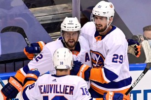 Brock Nelson (right) celebrates with Josh Bailey (12) and Anthony Beauvillier after scoring a goal in the Islanders' 4-0 Game 7 series-clinching victory over the Flyers.